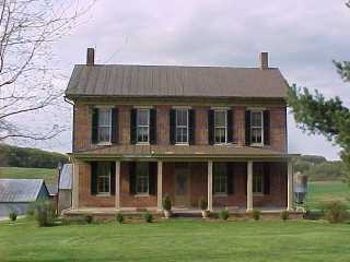 Bronze color roof wthbrick  siding by Roof Menders