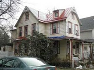 Roof Menders applied traditional red acrylic to colorful home near Philly