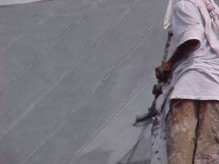 Roof Menders applies the slate grey top coating: the easy step