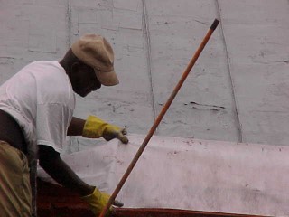 Crew chief Lester Mobley determines width needed for inside gutter work