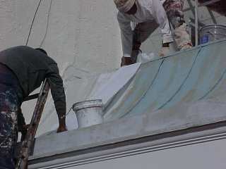 Roof Menders embeds mesh into base coating