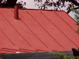 Closeup of sealer for tin roofs applied by Roof Menders' crew